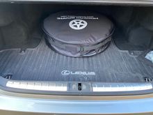 Modern spare in empty LS 500 trunk.