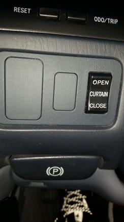 No air purifier but this button opens rear shade curtains and closes them when you want.