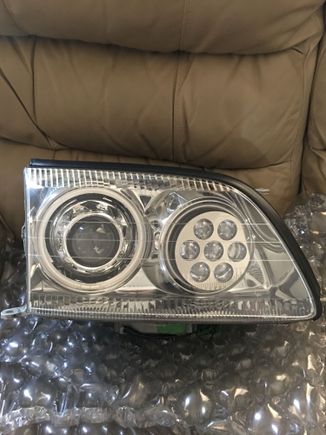 Retrofitted projector headlights with quad angel eyes and RGB demon eyes in high beam with Q45 shrouds