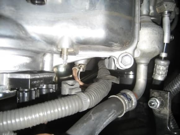 Wire harness mounted to valve cover.