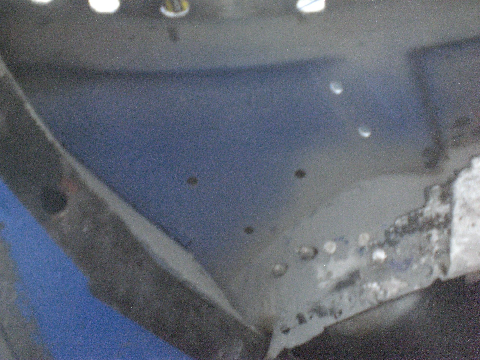 Temporarily mounting the support structure in place allowed me to re-drill the 3 rivet holes in it from underneath