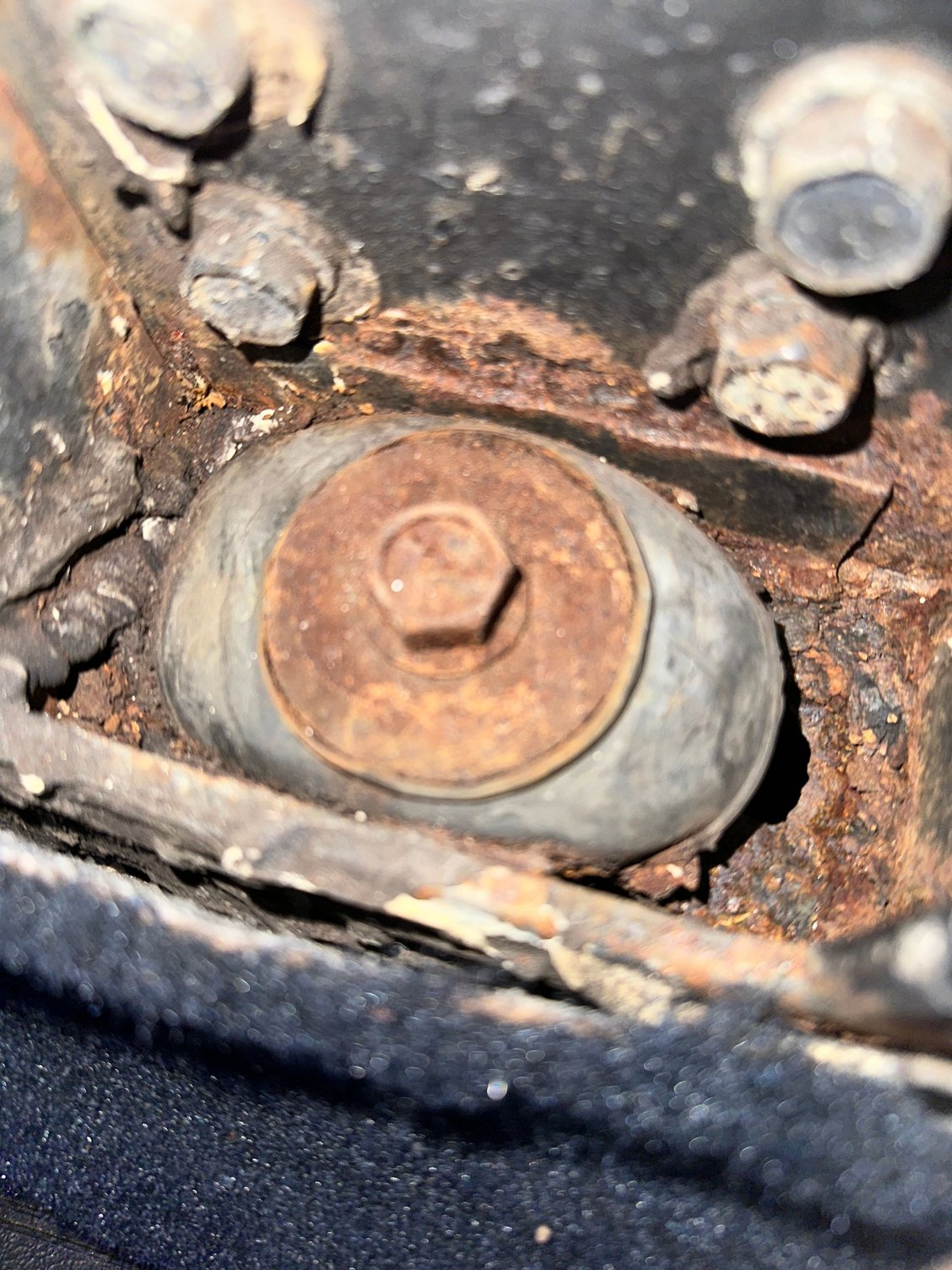 Pass side 2- hole in metal under rubber bushing
