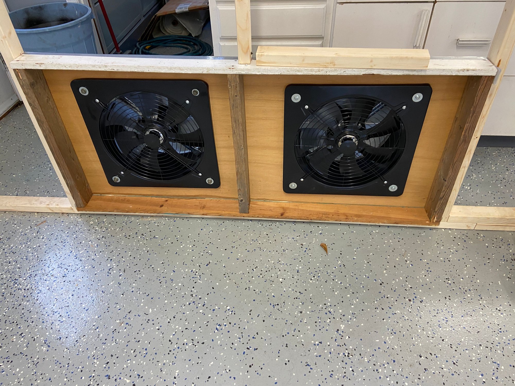 the 2 exhaust fans . The plenum is an old shelf I had laying around.  Still need to put some filters there to keep the solids from the overspray getting out.