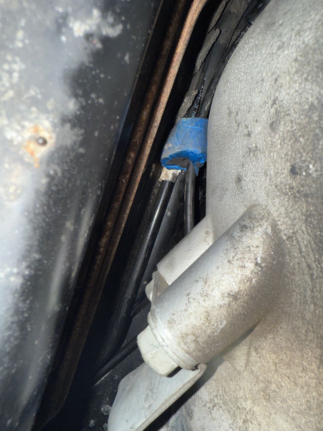Blue tape around the cable foam thing. Wants to curve up and under the drive shaft.