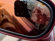 Water got behind the glass of the mirror, plus a b