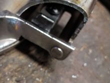Not the best pic, but you can see the spring steel and the heads of the screws here.  I made the angle cut on the spring because it was needed to the door lever swing arc.  I expected this--  and I could have relocated the spring but I wanted to stay in the original rivet centers. Worse comes to worse I'll go spend another 89 cents and redrill the holes in the spring steel.