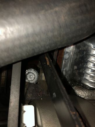 The chunk or hole in the bracket allows for the dip stick to be removed.