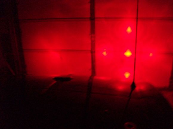 Brake lights in dark garage reflection on garage door - driver's side only.