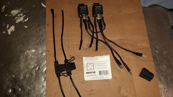 The three short wiring leads plug into the main wiring harness. The three long leads  plug into the headlight extension harness. And the two wires that were separated and I have to put connections on them will plug into the same spot as the long leads.