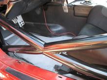 These X bars bend outward to help triangulate any impact load into the structure of the cage rather than buckleing straight into the driver.  They also alow more room for larger seats and drivers.  I also do these cars with Nascar style bars, wich recess into the doors fully, and are virtually non existent to the driver during operation.