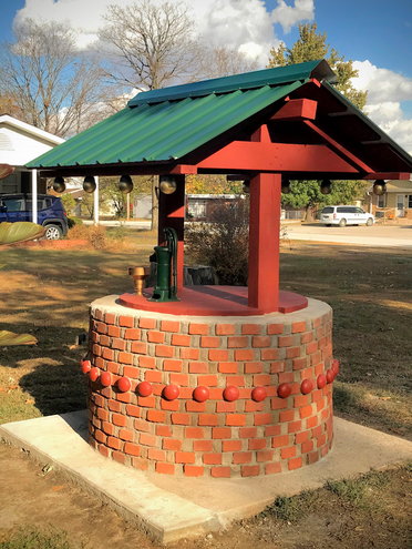 Our old well had a rotten wooden cover. In 2020, we replaced the wooden cover with a wishing well from reused bricks and lumber. The bricks and lumber came from an old house we tore down on our property. The materials if bought new cost about $750, but we only needed to spend about $50 to build this thanks to a gift from a friend and old mortar from a lumber yard.