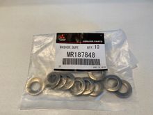 Mitsubishi OEM heavy-duty super washers (p/n MR187848). They are Belleville spring washers. 2 are needed for each manifold-to-turbo bolt.