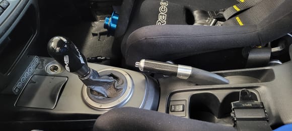 AMS Delrin shift knob (no too hot or too cold issues), Mitsubishi OEM carbon fiber e-brake handle.  Also pictured is Racetech 4009W fixed-back seats with Schroth 6 point harnesses.