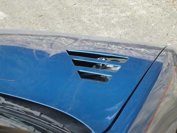 Coolant tank seen through the right-side hood vents