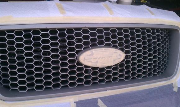 Here is the faded tan colored grill. Taped off and ready for paint.