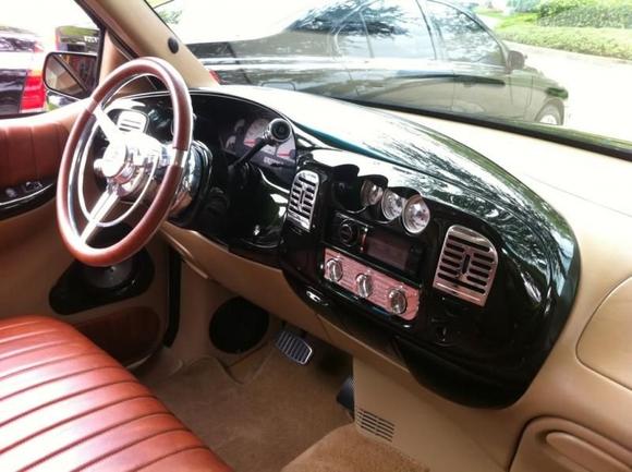 smoothed and painted dash, billet wheel, and custom radio gauge pod