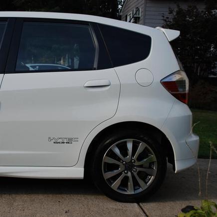 2013 Honda Fit Sport Drivers Side Rear. i-VTEC SOHC decal in black, 5% tinted rear cargo window.