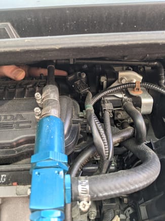 Reach your arm around the engine to to place your finger where my finger is located in the image. there's a vacuum line that it's resting on. ensure that it's connected.