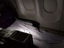 Fully reclined seat with makeshift mattress pad