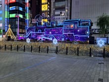 West entrance to Shimbashi station ( colours change with music regularly)-santa driving the train!