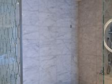 Huge shower room  ( bench and two shower heads). Aesop bottles on bench. Toilet next door ( separate glass  door) and large bath in main bathroom. Window between bathroom and bedroom ( as well as door) but blind can be electronically controlled for more privacy .Bath has a small tv also