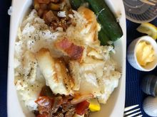 The ‘roasted halibut’ prelates in the casserole dish was literally four bites of halibut flakes. I noted the obvious bone sticking up as a sincere effort to make the bits of fish seem authentic. Also, inflight Wi-Fi is handy for checking the wines. None today cost more than US$12 a bottle online. 