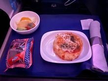 Cheese pizza an hour before arrival… other option was the couscous with veggies.  Really pathetic attempt at a business class meal.