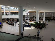 View from gate level down to the baggage claim and transportation level, complete with a stage for local music to listen to while you’re waiting for your bags