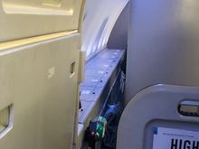 The gap at the side of 63K for squeezing out (taken from 62K). You can also see the side storage bins, which all UD window seats have. 