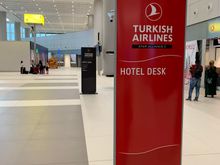 Hotel desk, to the very right when you leave the baggage claim area 