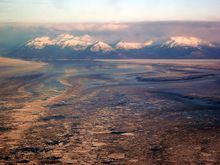 Swirling currents create a colorful tapestry of sea ice on approach to  King Salmon, Alaska