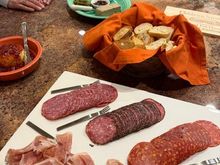 Dick liver pate with port and chicken liver and pork pate with cornichon and fig configure, various meats, Boursin with red pepper and bacon jam and more baguette slices and crostini