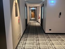 I did not hear any noise from the hallway. The doors seem quite solid.