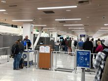 At the head of the Pre line. There is only one Pre TSA officer and only one belt/xray shared by both Pre and Clear which accounts for the long line. 