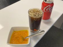 Rum-and-Coke in the middle and a carrot soup to the left 