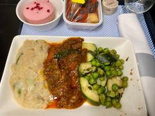 Braised neck of lamb with mint and cumin, butterbean mash, peas and courgette