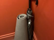 With a yoga mat and umbrella