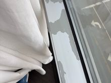 Peeling paint along the windows.