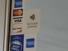 Tap to pay sticker on entry door (one above the "Shop Small" logo, right of the networks)