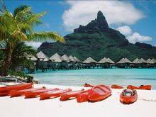 The fluorescent red kayaks strike resplendent pose against the colors of the lagoon