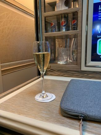 Champagne on take off and one side of mini bar behind. 