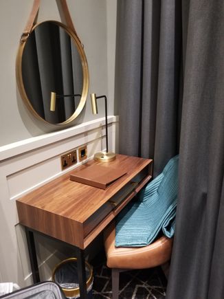 Desk in tiny corner with hanging mirror