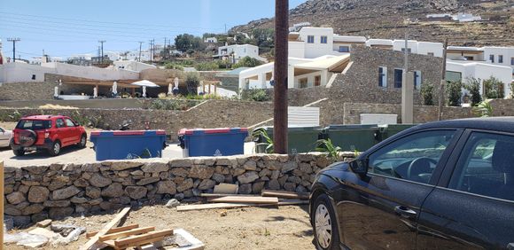 Our rental car parked in the dirt lot. Hotel in front of us.