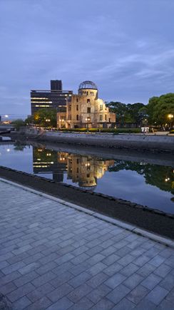 The A-dome building taken just after sunset from across the river with a beautiful reflection  in the still waters ( a few seconds later a small cruise boat passed by and its wake stirred up the waters). Dusk and night time are beautiful times to visit the A-dome and Peace park as they take on a different presence at night and with a lot fewer people  around



