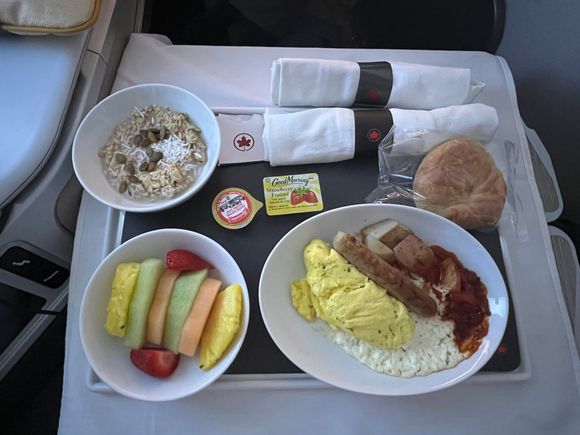 Japchae noodle wasn’t available since I sat on the last row. 
MAIN COURSE
Parsley omelette, chicken sausage, cottage cheese, roasted potatoes, red pepper relish - 8/10
Korean pork japchae
ACCOMPANIMENTS
Fresh seasonal fruit - 10/10
Muesli, apples, raisins, coconut, pumpkin seeds - 8/10
Croissant, butter, jam 0/10. Stone cold bread….