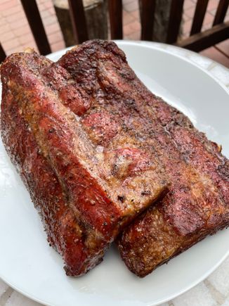 Rack of baby back ribs, salt and pepper dry rubbed, and smoked in the pizza oven over mesquite and cherry wood for 3 hours. Great smoke flavor and color and tender and moist. Happy Friday!