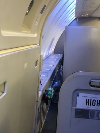The gap at the side of 63K for squeezing out (taken from 62K). You can also see the side storage bins, which all UD window seats have. 