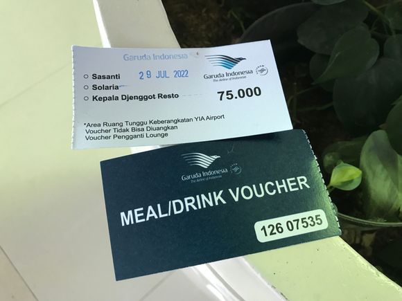 The Garuda Lounge is not open yet so they provide per person a voucher worth 75.000 IDR (good for a hot meal + drink) at participating venues