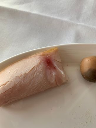 I'm sure that the red spot is just where they injected the "smoke flavour" into the meat but I ain't risking eating white meat with red spots on an aeroplane.