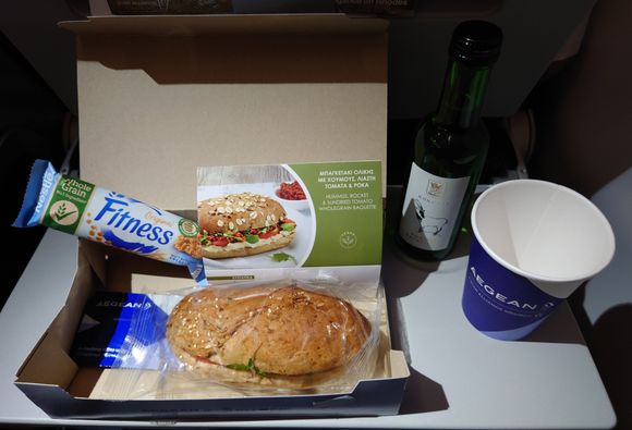 Aug 2022, A3609, economy - hummus, rocket, and sundried tomato wholegrain baguette; Nestlé wholegrain fitness bar; white wine